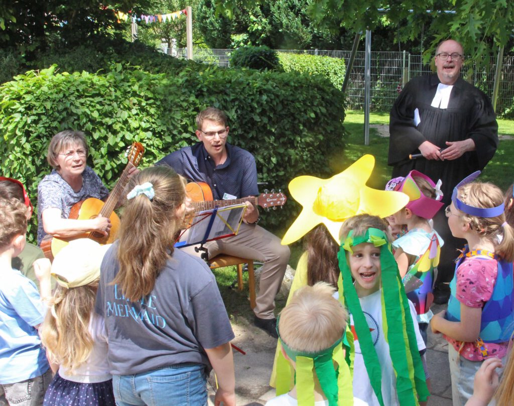 Die ehemalige Leiterin Lidia Harder, Einrichtungsleiter Jens Tegethoff und Pfarrer Holger Nolte-Guenther singen mit den Kindern.Foto: Burkhard Battran 
